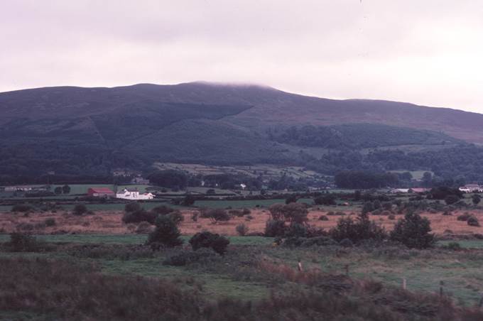 A picture containing sky, outdoor, mountain, grass
Description automatically generated
